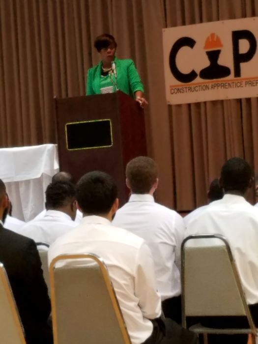 A guest speaker congratulates the graduates