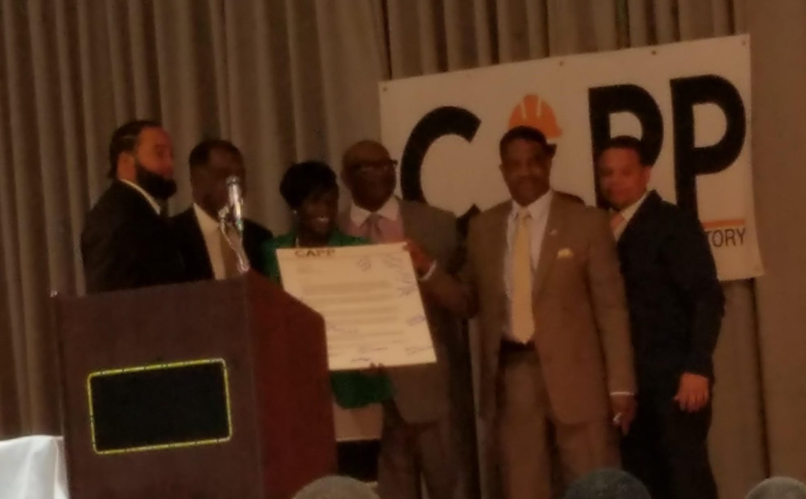 Graduates and leaders on stage at the CAPP graduation ceremony